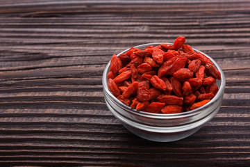 dried goji berries on a wooden rustic background