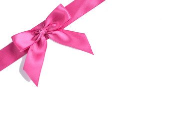 Pink satin ribbon bow isolated on white background.