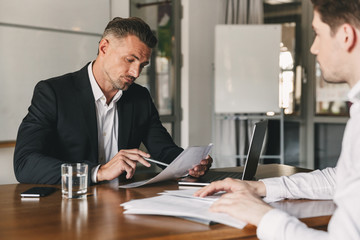 Business, career and placement concept - caucasian businessman 30s negotiating with male employer...