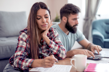 Young couple doing family finances at home