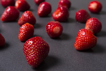 Berries of ripe red strawberries on a black background.