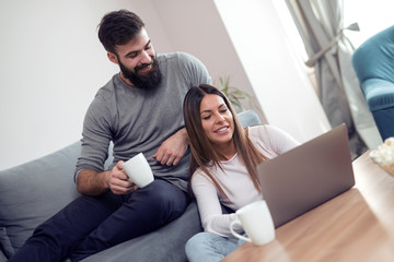 Young couple surfing with laptop