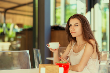 Happy woman at outdoors cafe