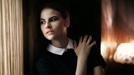 Sad Woman looking out the Window. Cinematic Portrait