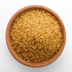 raw bulgur on a white acrylic background