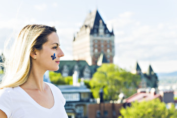 Woman celebrates the national holiday in front of Chateau Frontenac in quebec city