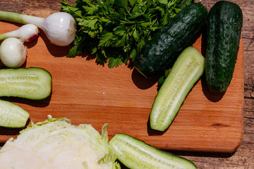 Ingredients for spring vegetable salad on rustic wooden table
