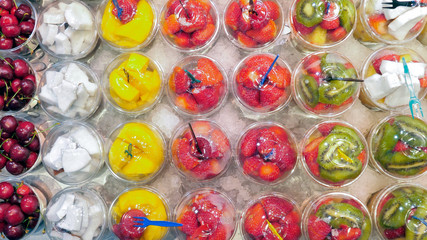 Fresh squeezed fruit juice in plastic cups at La Boqueria market, Barcelona