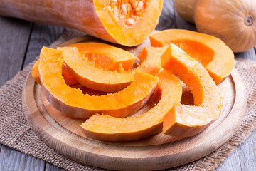 Slices of raw pumpkin on a cutting board