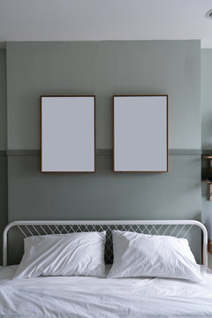 Cozy bedroom headboard with 2 empty frame on green painted wall / Cozy Interior Concept / Bedroom