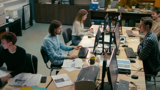 Business Group of Casual People is Working in the Open Space Office at Common Desk with Computers