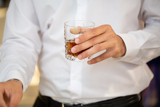 A Men Holding A Whiskey Glass