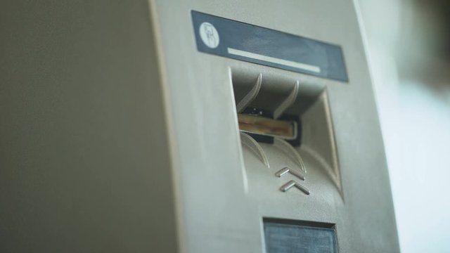 ATM reader taking credit card and returning it after identification, security