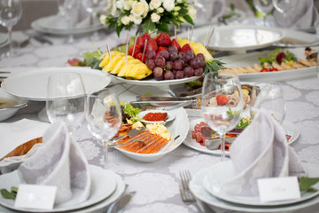 Buffet table of reception with cold snacks, meat, salads and fruits