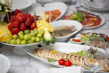 Buffet table of reception with cold snacks, meat, salads