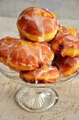 Polish donuts with icing on a wooden background