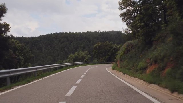 Timelapse shot driving car in windy countryside road in catalonia Spain