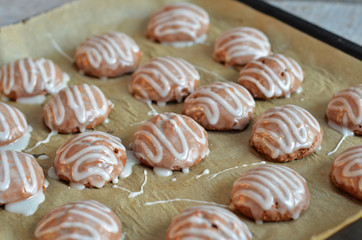 Soft round gingerbreads covered with icing on paper