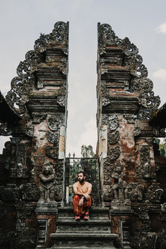 .Young and cheerful tourist enjoying the island of Bali in Indonesia. Knowing ancient Hindu temples, very spiritual places. Travel Photography. Lifestyle..