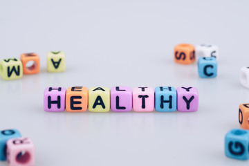 Obraz premium Healthy word text written on colorful cube with bokeh cube word block background