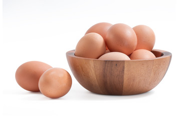 Eggs isolated in wooden bowl on white background