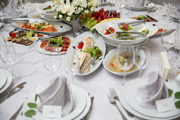 Buffet table of reception with cold snacks, meat, salads and fruits