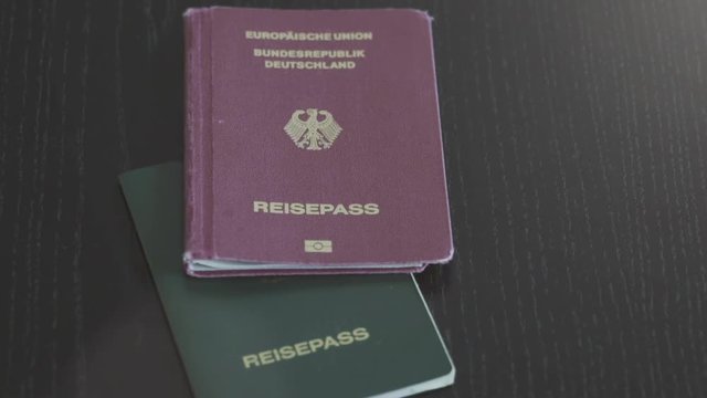 Travel Passport background concept footage. The european German Passport on a wooden desktop