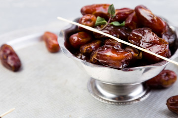 Dry fruit dates on silver tray. Copy space.