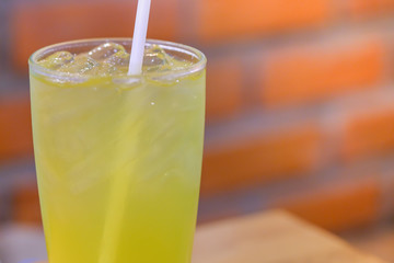 Close up of glass of iced japanese green tea with  straw in restaurant.