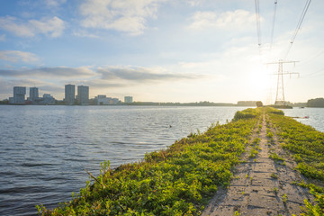 Skyline of a city along the shore of a lake at sunrise in spring