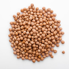 uncooked chickpeas on a white acrylic background