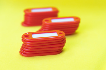 key tags stacked in stacks on a yellow background