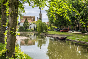 landscape with canal and church dome. edam netherlands