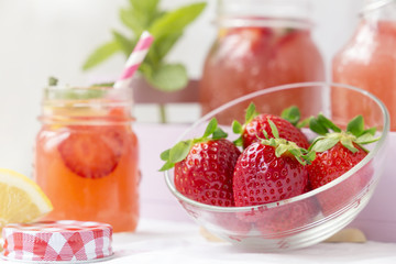 Fototapeta na wymiar Retro glass jar of detox water with strawberries, lemon and mint