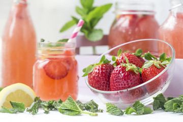 Retro glass jar of detox water with strawberries, lemon and mint