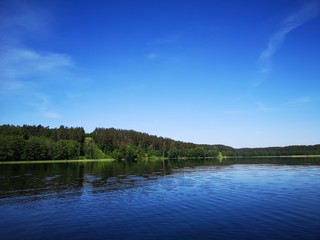 Obraz na płótnie Canvas A hill near a blue clear lake