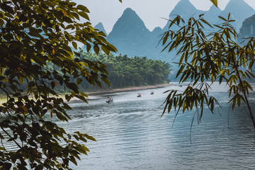 Scenic landscape at Yangshuo County of Guilin. Li River (Lijiang River). Pleasure boats at the pier...