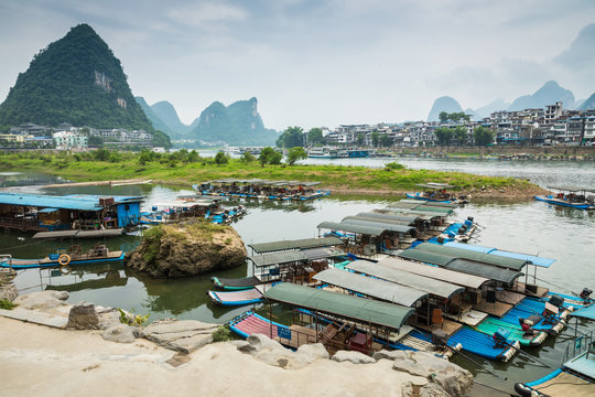 Scenic landscape at Yangshuo County of Guilin. Li River (Lijiang River). Pleasure boats at the pier in Yangshuo Town, China.