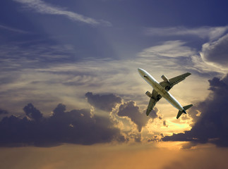 Fototapeta na wymiar Large airliner in cloudy sky