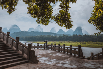 Scenic landscape at Yangshuo County of Guilin. Li River (Lijiang River). Pleasure boats at the pier...