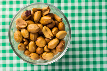 Peanuts on bowl and plaid green table. Food of Festa Junina, a typical brazilian party.