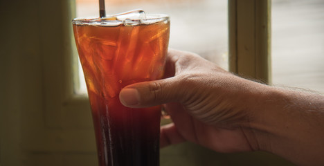 Closeup of hands with ice coffee cups in a cafe