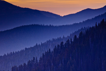 Naklejka na ściany i meble Layers of mountains silhouettes in the fog at sunset, Pacific North West, Olympic National Park, Washington State, USA