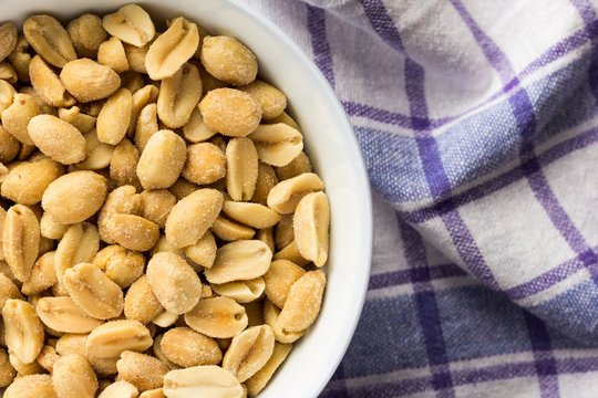 Peanuts. Food of Festa Junina, a typical brazilian party. Snacks on bowl and rustic fabric.