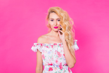 Fototapeta na wymiar Beautiful girl wearing dress posing on pink background in studio. Summer, holidays and fashion concept