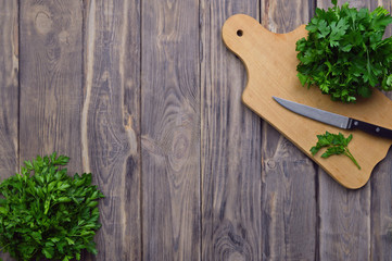 Fresh parsley on a cutting board and a knife. cooking. Healthy eating. Greenery. Top view. The concept of a healthy diet.