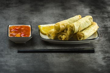 Spring rolls, chopsticks and sauce