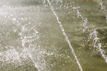 Flow of water fountain. Water splash in a fountain, abstract image.