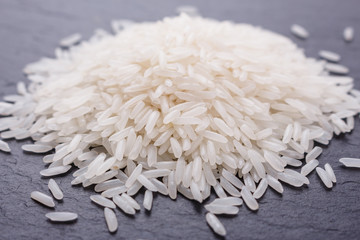 Jasmine rice on a dark stone background