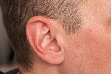 Obraz premium a handsome man shaves his beard, his beard grows not evenly